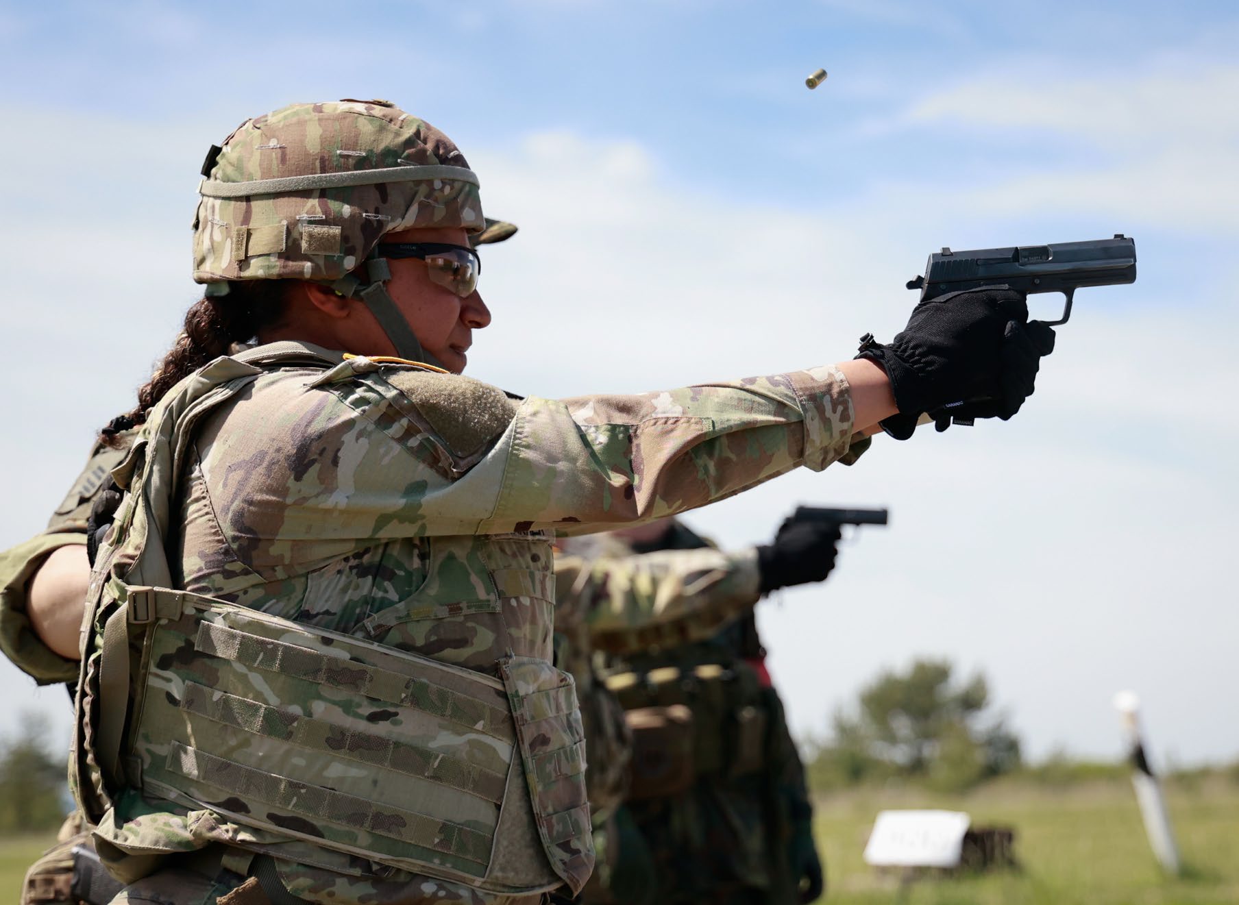 SGT Jiyah Warner, then-paralegal specialist, 21st Theater Sustainment Command,
            fires an HK P8 A1 service pistol during a
            drill for the Schützenschnur, or German
            Armed Forces Badge, for a marksmanship
            event in Ohrdruf, Germany. (Credit: SPC
            Samuel Signor)